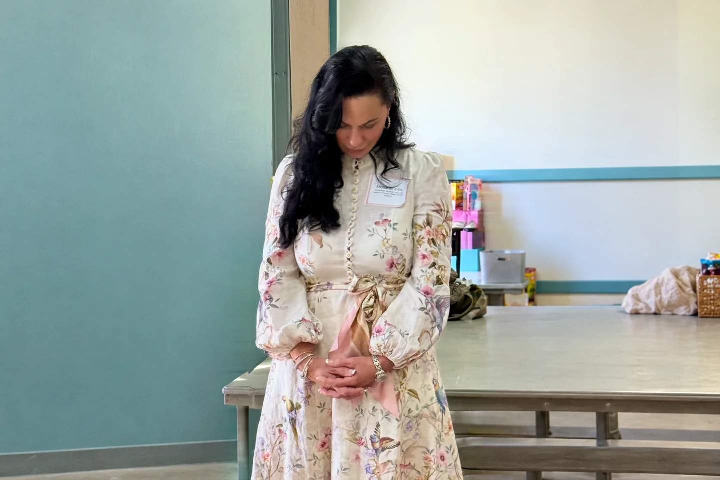 Melanie Cox pausing with her hands folded